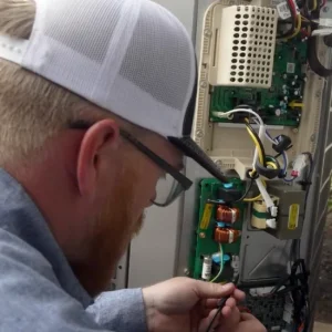 image of TECHNICIAN SERVICING HEATING SYSTEM